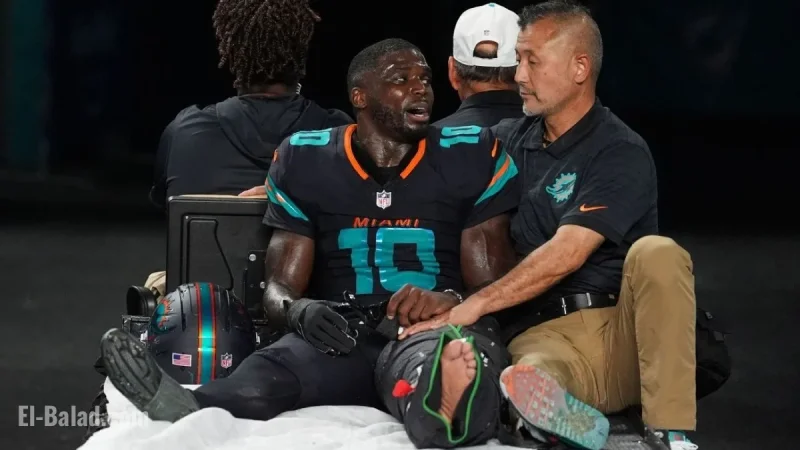 Dolphins Star Hill Exits Game with Left Knee Injury in Air Cast