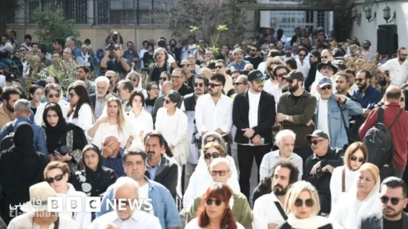 Pallbearers in White Carry Nasser Taghvai’s Coffin