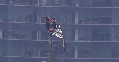 Two Masked Climbers Raise Peace Banner on Empire State Building