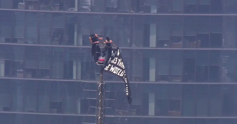 Two Masked Climbers Raise Peace Banner on Empire State Building