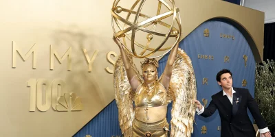 Megan Stalter Arrives at Emmys in Gold Emmy Award Look