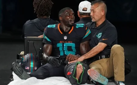 Dolphins Star Hill Exits Game with Left Knee Injury in Air Cast