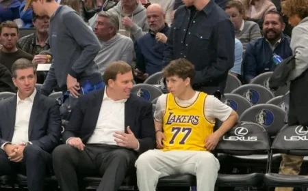 Mavericks Fan in Doncic Lakers Jersey Chats Courtside with Patrick Dumont