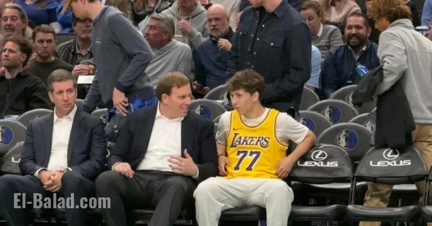 Mavericks Fan in Doncic Lakers Jersey Chats Courtside with Patrick Dumont
