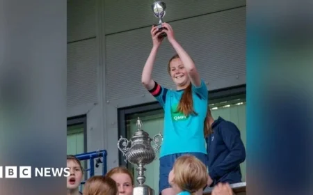 Girls’ Football Team Awarded Small Cup, Boys Win Full-Size Trophy