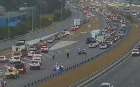 Tonkin Highway shut after serious crash traps motorcyclist under car