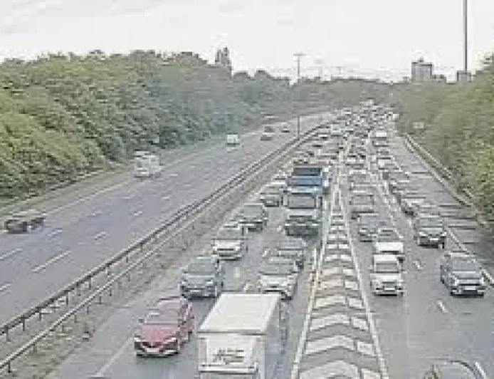 M60 clockwise closed between junctions 22 and 23 after car blocks road